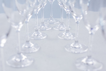 Glasses for champagne on a blue background, glass dishes for drinks