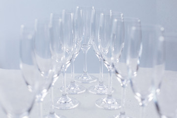 Glasses for champagne on a blue background, glass dishes for drinks