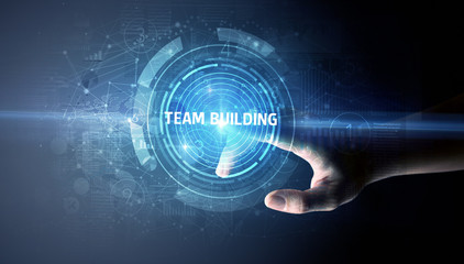 Hand touching TEAM BUILDING button, modern business technology concept