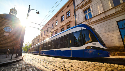 Fototapeta Tram on the street of old town in Krakow, Poland. Cityscape with polish public transport . obraz