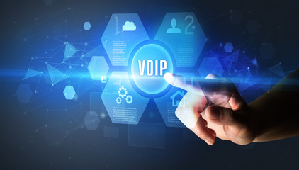 Hand touching VOIP inscription, new technology concept