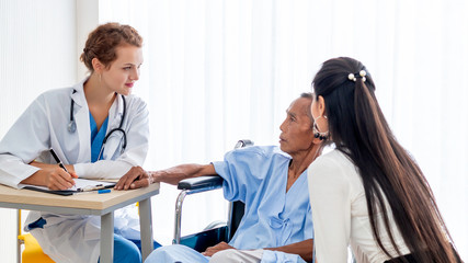 Fototapeta premium Medical professionals Caucasian woman examining senior man patient with stethoscope in the hospital room.