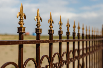 Wrought iron fence with decorative arrows