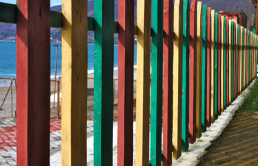 Multi-colored fence by the sea