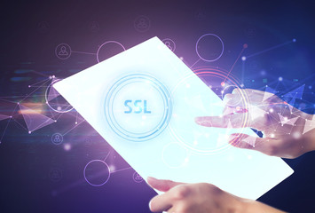 Hand holdig futuristic tablet with SSL inscription, modern technology concept