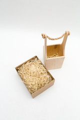 wooden empty bottle bag and cardboard box with  packaging tinsel on a white background