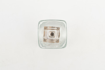 Vintage glass decanter made of transparent glass without a pattern on a white background top view