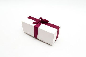 white gift box with a red bow on a white background