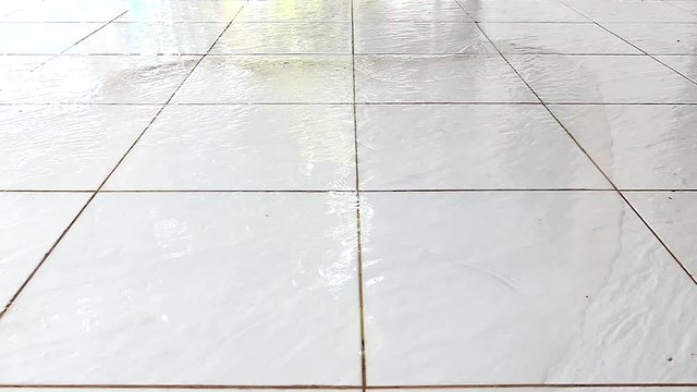 Clean the tile floor with a splatter of water.