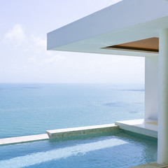 View of the villa and sea landscape with a blue pool in a minimalist style. Rich and luxurious life in the tropics of the island