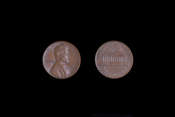 1 CENT 1964 LINCOLN PENNY US COIN. Black background, close-up.