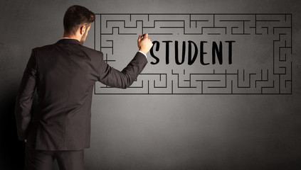 businessman drawing maze with STUDENT inscription, business education concept