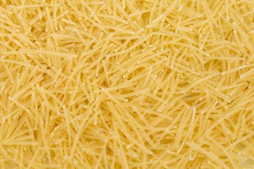 Raw vermicelli pasta (italian pasta) background, close up