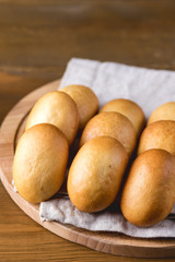 Traditional Small Russian Pies on Wooden Tray Wooden Background Vertical
