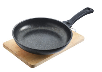 Non-stick aluminum pan on a wooden cutting board on a white background