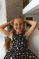 Little girl with red hair shows different emotions. Sadness, joy and happiness. She smiles and cries. In a black dress with skin pigment on her face, freckles