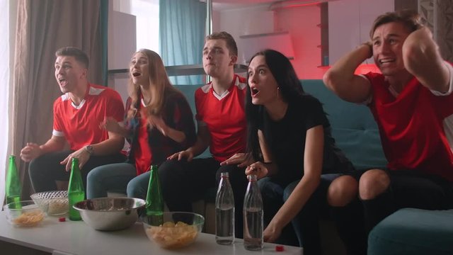 A group of men and women are emotionally shouting and cheering for their favorite team at the world Cup, America's Cup, Euro, and Olympic games. The joy of winning and scoring a goal - Powered by Adobe