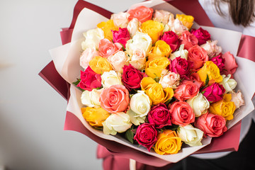 Beautiful roses in hands. Spring, summer, flowers, color concept. Flower delivery