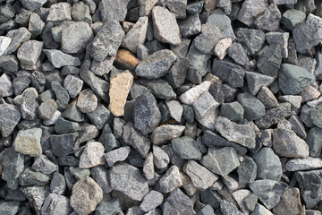 Background from gray high-strength crushed stone of high resolution. Small stones in the form of crushed stone close-up.