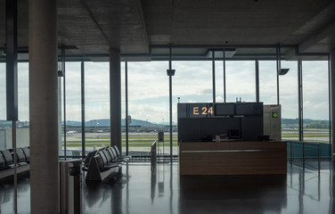 Information counter and black seats at terminal waiting area in Zurich Kloten airport on beautiful outdoor view background with copy space , Switzerland