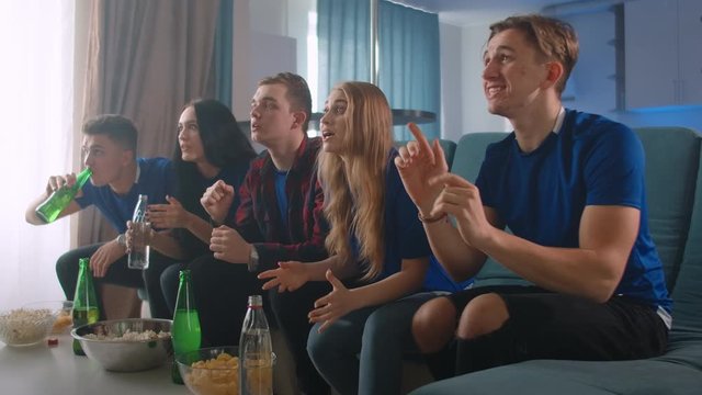 Five friends watch the Olympics on TV while sitting at home and celebrate emotionally!! the joy of winning and winning the championship.