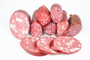 Smoked sausage in assortment on a white background