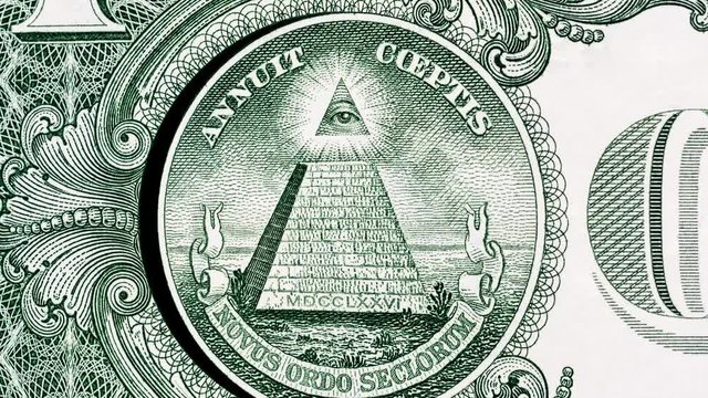 Creative 4k parallax video of details of a 1 American dollar banknote with a rotating circle with a pyramid and an eye at the top.