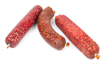 Smoked sausage in assortment on a white background