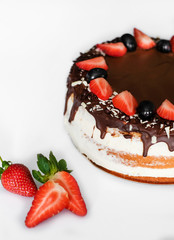 Strawberry cake with chocolate on top at white background. Isolated