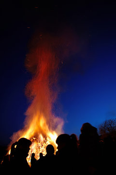 People standing in front of a traditional Easter fire in Germany