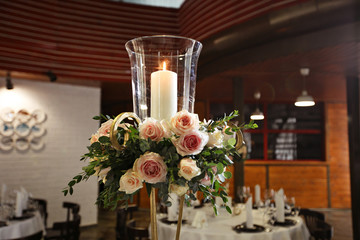 candle with glass candlestick decorated flowers