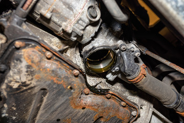 Unscrewed oil filter in the diesel engine from its mounting place at the bottom of the engine next...