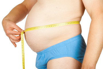 A fat man measures his waist with a measuring tape