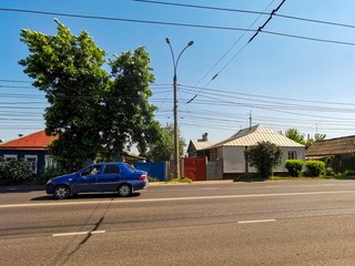 A car in front rural houses in Kursk