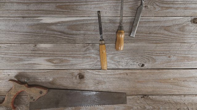 Vintage woodworking tools on a wooden background. Hand tools moving and filling the frame. Neatly organized tools. Carpentry, diy, craftmanship, knolling concept,  flat lay, 4k stop motion animation