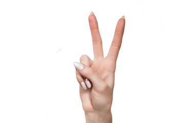 Naklejka premium the female hand shows gesture a victory is isolated on a white background