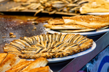 Cooked, fried dorado, mackerel and hamsa fish fillets at a street fish market in the Turkish city of Kayseri