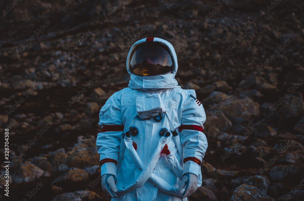 Wall mural astronaut exploring a new planet. searching for a new home for humanity. concept about science and n