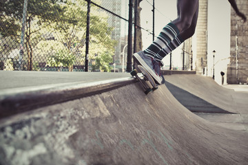 Young girl performing tricks with the skateboard in a skate park