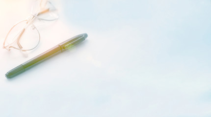 Note pad, pen, glasses on a white background. Business concept. Morning, office. Space for text