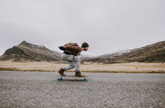 Skater traveling iceland on his longboard