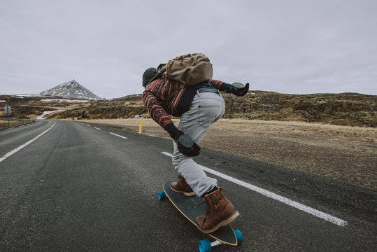 Skater traveling iceland on his longboard