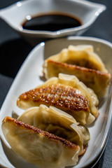 Crispy and steamed dumplings with soy sauce