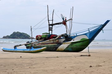 Naklejka na ściany i meble old fishing boat on the beach, Weligama, Sri Lanka