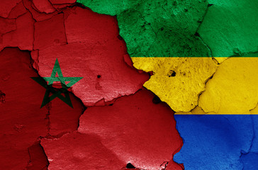 flags of Morocco and Gabon painted on cracked wall