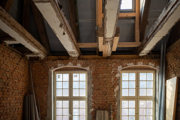 in an old building that is being restored, old wooden beams are reinforced with new beams