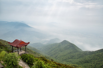 The hazy scenery of the mountain peak filled with clouds
