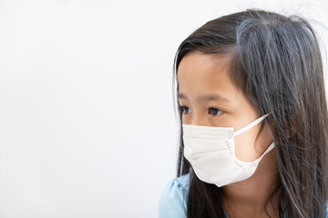 Asian girl wearing surgical mask to prevent PM2.5 air pollution and virus in year 2020