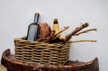 Wine basket with wine bottles and grapevine