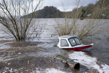 Boat capsized sunk in flooded lake due to deep sinking river water Balmaha in Loch Lomond